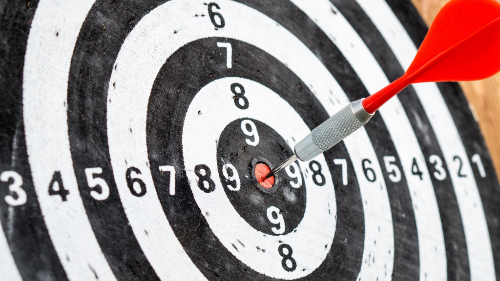 Picture of a dart board with a dart in the bullseye position symbolising having found your financial number..